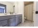 Bathroom features double sinks, gray cabinets, and patterned flooring at 7093 Republic Ln, Indianapolis, IN 46259