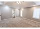Large bedroom with carpet, a tray ceiling, recessed lights, ceiling fan, bathroom entrance, and windows at 7093 Republic Ln, Indianapolis, IN 46259