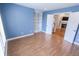 Spacious bedroom showcases laminate floors, custom built-in shelving, and access to living room at 7093 Republic Ln, Indianapolis, IN 46259