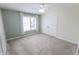 Bright bedroom with a neutral color palette, plush carpet, a ceiling fan, and a closet at 7093 Republic Ln, Indianapolis, IN 46259