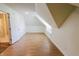 Bright bonus room featuring wood-look floors, natural light, and access to an ensuite bathroom at 7093 Republic Ln, Indianapolis, IN 46259