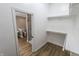 Open walk-in closet with white racks leading to the bathroom at 7093 Republic Ln, Indianapolis, IN 46259