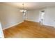 Spacious dining room with hardwood floors, chandelier, and access to other living spaces at 7093 Republic Ln, Indianapolis, IN 46259