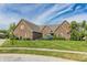 Beautiful brick home boasts mature trees, a well-manicured lawn, and classic design at 7093 Republic Ln, Indianapolis, IN 46259