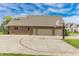 Brick home with a basketball court and a three car garage in the background at 7093 Republic Ln, Indianapolis, IN 46259