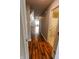 Hallway with wood floors leading to an open area and a bathroom with shower at 7093 Republic Ln, Indianapolis, IN 46259