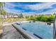 Inviting backyard hot tub with a view of neighboring homes, lush landscaping, and blue skies at 7093 Republic Ln, Indianapolis, IN 46259