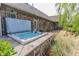 Relaxing hot tub on brick patio next to home with backyard view and lush landscaping at 7093 Republic Ln, Indianapolis, IN 46259