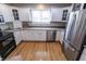 Bright kitchen features white cabinetry, stainless steel appliances, and natural light at 7093 Republic Ln, Indianapolis, IN 46259