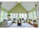 Sunroom offers natural light with vaulted ceilings, large windows and comfortable couches at 7093 Republic Ln, Indianapolis, IN 46259