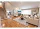 Bright living room features hardwood floors, a fireplace, and large windows for natural light at 7093 Republic Ln, Indianapolis, IN 46259