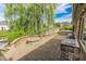 Brick patio with a built-in grill and a fire pit near a pond at 7093 Republic Ln, Indianapolis, IN 46259