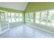Bright sunroom with multiple windows offering abundant natural light and outdoor views at 7093 Republic Ln, Indianapolis, IN 46259