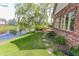 Backyard with a pond, brick patio and fire pit near the brick home at 7093 Republic Ln, Indianapolis, IN 46259