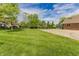 Backyard with a basketball court and a home in the background at 7093 Republic Ln, Indianapolis, IN 46259