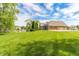 Backyard featuring a basketball court, large lawn, and a home in the background at 7093 Republic Ln, Indianapolis, IN 46259