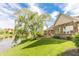 Lawn near pond and patio with a brick home in the background at 7093 Republic Ln, Indianapolis, IN 46259