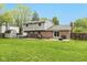 Large backyard featuring a patio with furniture, a hot tub, shed, and lush green lawn at 713 Colonial Way, Greenwood, IN 46142