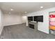 Finished basement with gray carpet and a cozy fireplace with dual wall-mounted televisions at 713 Colonial Way, Greenwood, IN 46142