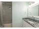 Bathroom featuring a shower with white subway tile and a vanity with a granite countertop at 713 Colonial Way, Greenwood, IN 46142
