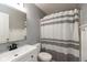Clean bathroom with a shower-tub combo, modern vanity, updated fixtures, and neutral decor at 713 Colonial Way, Greenwood, IN 46142