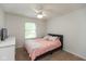 Comfortable bedroom with neutral carpet, ceiling fan, window, and a closet for storage at 713 Colonial Way, Greenwood, IN 46142