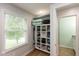 Bright closet with white shelving and storage, next to a window letting in lots of natural light at 713 Colonial Way, Greenwood, IN 46142