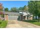 Charming two-story home with well-maintained lawn, brick accents and a gray garage door at 713 Colonial Way, Greenwood, IN 46142