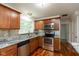 Well-lit kitchen with stainless steel appliances, granite countertops, and a modern backsplash, great for cooking at 713 Colonial Way, Greenwood, IN 46142
