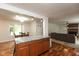Open-concept kitchen island with stone countertop that connects the kitchen to the dining and living areas at 713 Colonial Way, Greenwood, IN 46142