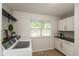 Practical laundry room with modern appliances, ample storage, and a window offering natural light at 713 Colonial Way, Greenwood, IN 46142
