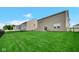 The backyard features a well-kept lawn, backing to other neighboring houses at 7226 Sayers Rd, Indianapolis, IN 46259