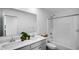 Bright bathroom featuring a double vanity, quartz countertop, and shower-over-tub at 7226 Sayers Rd, Indianapolis, IN 46259