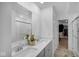 Bathroom with double sink vanity, quartz countertop, and a view into the walk-in closet at 7226 Sayers Rd, Indianapolis, IN 46259