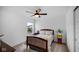 Bedroom with a ceiling fan and natural light, complemented by cozy decor and carpet at 7226 Sayers Rd, Indianapolis, IN 46259