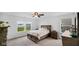Well-lit bedroom featuring a comfortable bed, neutral carpet, and picturesque outdoor views at 7226 Sayers Rd, Indianapolis, IN 46259