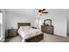 Well-lit bedroom featuring a comfortable bed, a ceiling fan and picturesque outdoor views at 7226 Sayers Rd, Indianapolis, IN 46259
