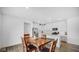 Dining area adjacent to a modern kitchen, featuring a rustic wooden table with four chairs at 7226 Sayers Rd, Indianapolis, IN 46259