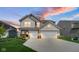 Two-story home with three-car garage, neutral siding, and a well-manicured lawn at 7226 Sayers Rd, Indianapolis, IN 46259