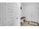 Hallway featuring neutral walls, a built-in bench, and natural wood flooring at 7226 Sayers Rd, Indianapolis, IN 46259