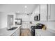 Modern kitchen with white cabinets, stainless steel appliances, and a large island at 7226 Sayers Rd, Indianapolis, IN 46259