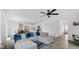 Open concept living room featuring a kitchen, dining area, and comfortable gray sectional at 7226 Sayers Rd, Indianapolis, IN 46259