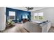 Stylish living room featuring an accent wall, modern furniture, and bright windows at 7226 Sayers Rd, Indianapolis, IN 46259