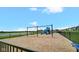 Community playground featuring swings and a climbing structure near the lake at 7226 Sayers Rd, Indianapolis, IN 46259