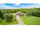 Expansive aerial view showcasing the charming brick home, lush greenery, and long driveway at 7333 State Road 42, Martinsville, IN 46151