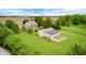 A large two-story home with an additional outbuilding, surrounded by a lush, green, well-maintained lawn at 7333 State Road 42, Martinsville, IN 46151