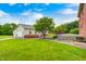 Large backyard featuring green lawn, garden, cottage, and deck, offering ample outdoor space at 7333 State Road 42, Martinsville, IN 46151