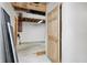 Unfinished basement with a door, concrete floor, and exposed ceiling, waiting to be transformed at 7333 State Road 42, Martinsville, IN 46151