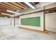 Unfinished basement with a large chalkboard and wood studs at 7333 State Road 42, Martinsville, IN 46151