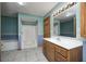 Bathroom featuring a double vanity sink, walk-in shower, and soaking tub with a blue and white color scheme at 7333 State Road 42, Martinsville, IN 46151